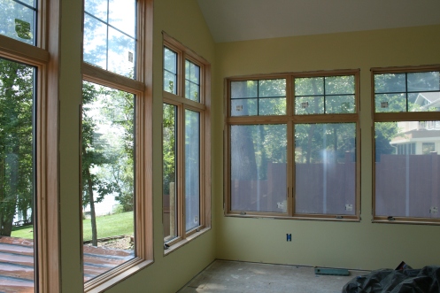 The sunroom, in a nice, soft yellow. (Look at the view out the windows - looks like a treehouse!)